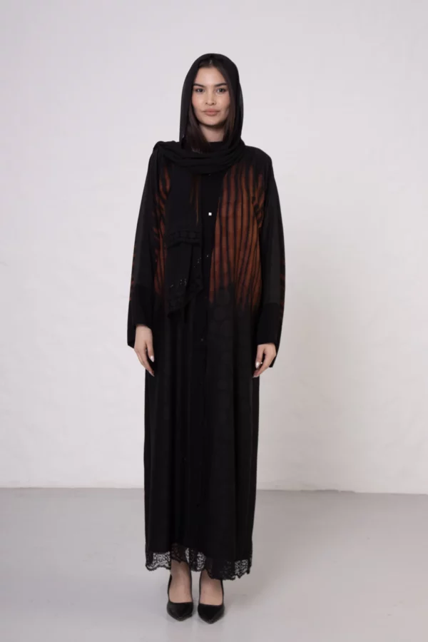 Brown zebra-print abaya with snap closings.