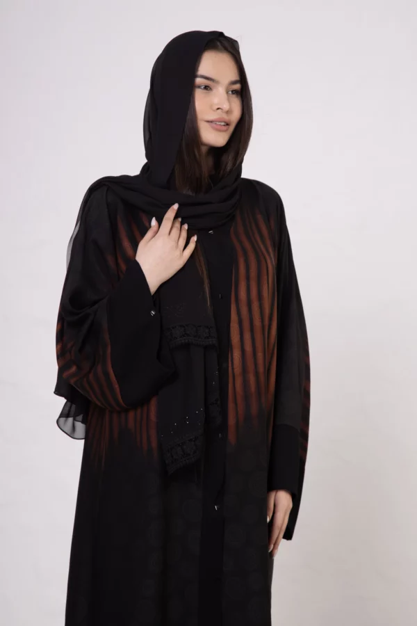 Brown zebra-print abaya with snap closings.