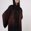 Brown zebra-print abaya with snap closings.