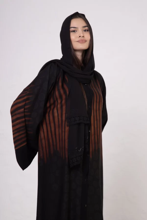 Brown zebra-print abaya with snap closings.
