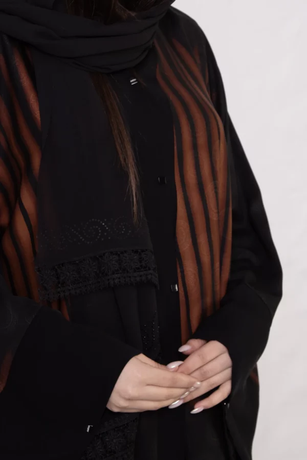 Brown zebra-print abaya with snap closings.