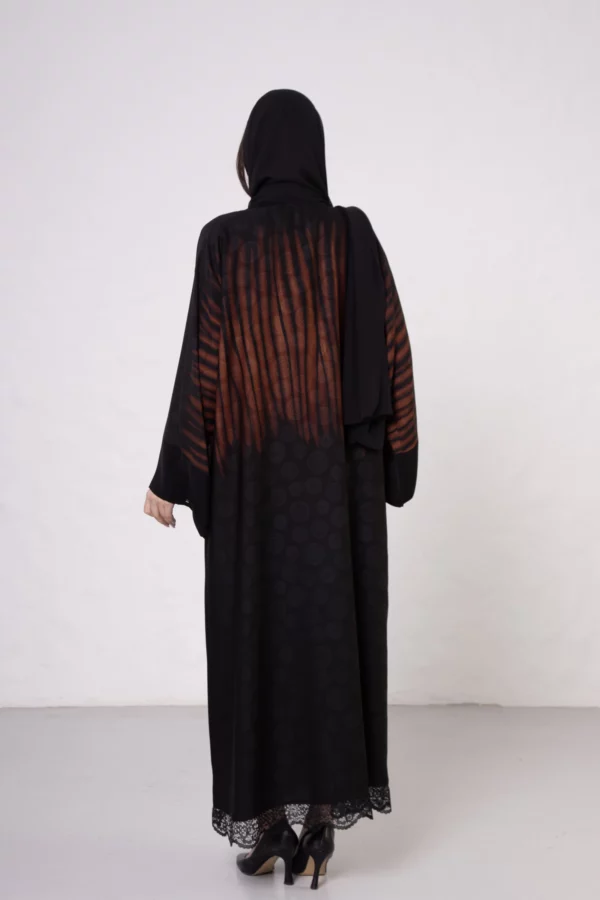 Brown zebra-print abaya with snap closings.
